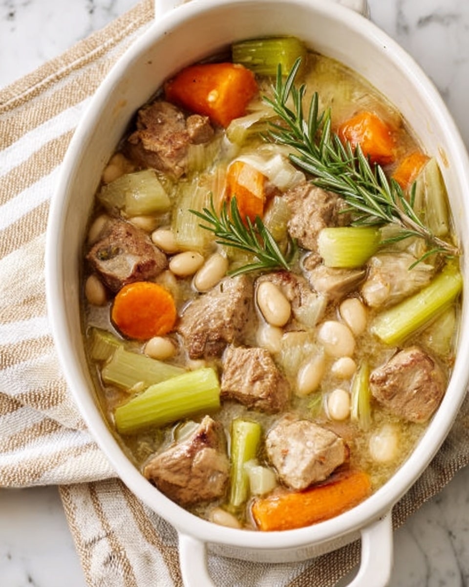 The image shows a white oval ceramic dish filled with a hearty stew. The stew has large chunks of orange carrots and thick pieces of light green leeks standing upright, mixed with small pieces of cooked brown meat and a handful of pale white beans. Sprigs of fresh green herbs, likely rosemary, are placed on top for garnish. The dish is placed on a soft striped cloth atop a white marbled surface. photo taken with an iphone --ar 4:5 --v 7