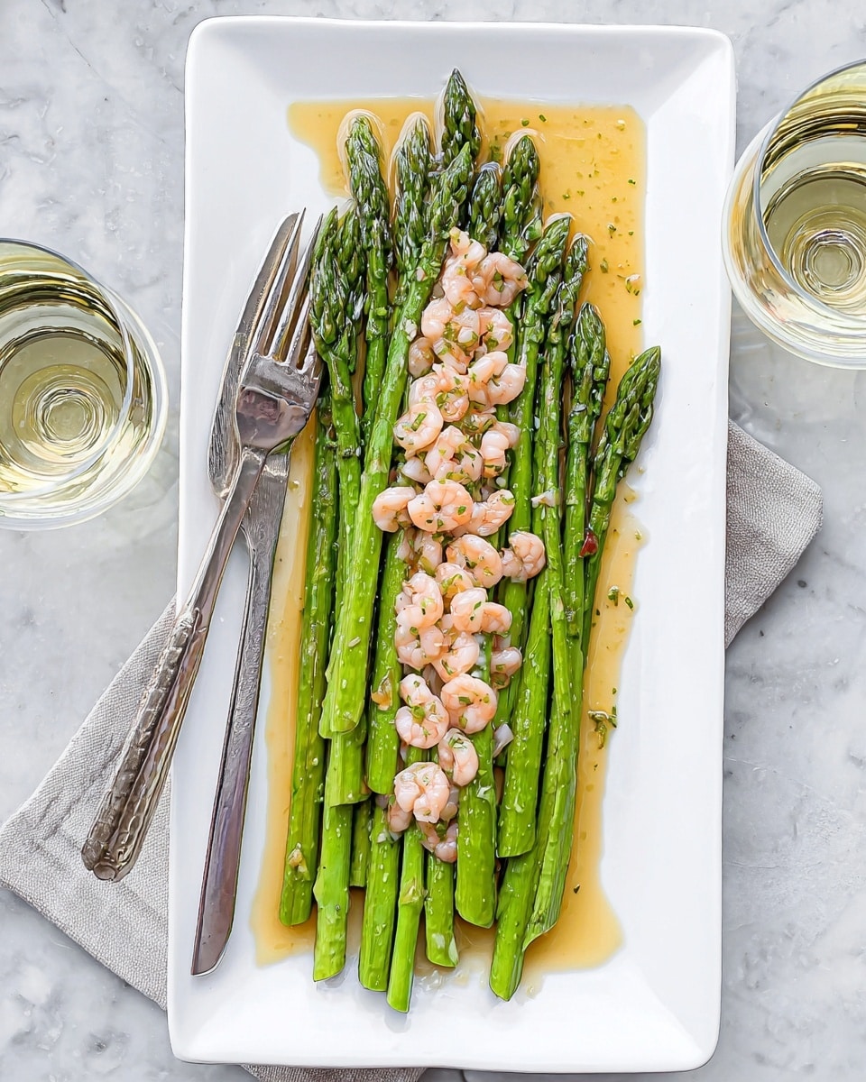 A white rectangular plate on a white marbled surface holds a dish of green asparagus spears neatly arranged in two parallel rows, topped with a generous line of small light brown shrimp scattered along the center. The asparagus looks tender and glossy with a light drizzle of golden sauce pooling slightly on the plate. A silver fork and knife rest on the left side of the plate, with a woman's hand holding the fork gently picking at the asparagus. Two glasses with a light clear liquid sit near the top left and right edges of the image. Photo taken with an iphone --ar 4:5 --v 7