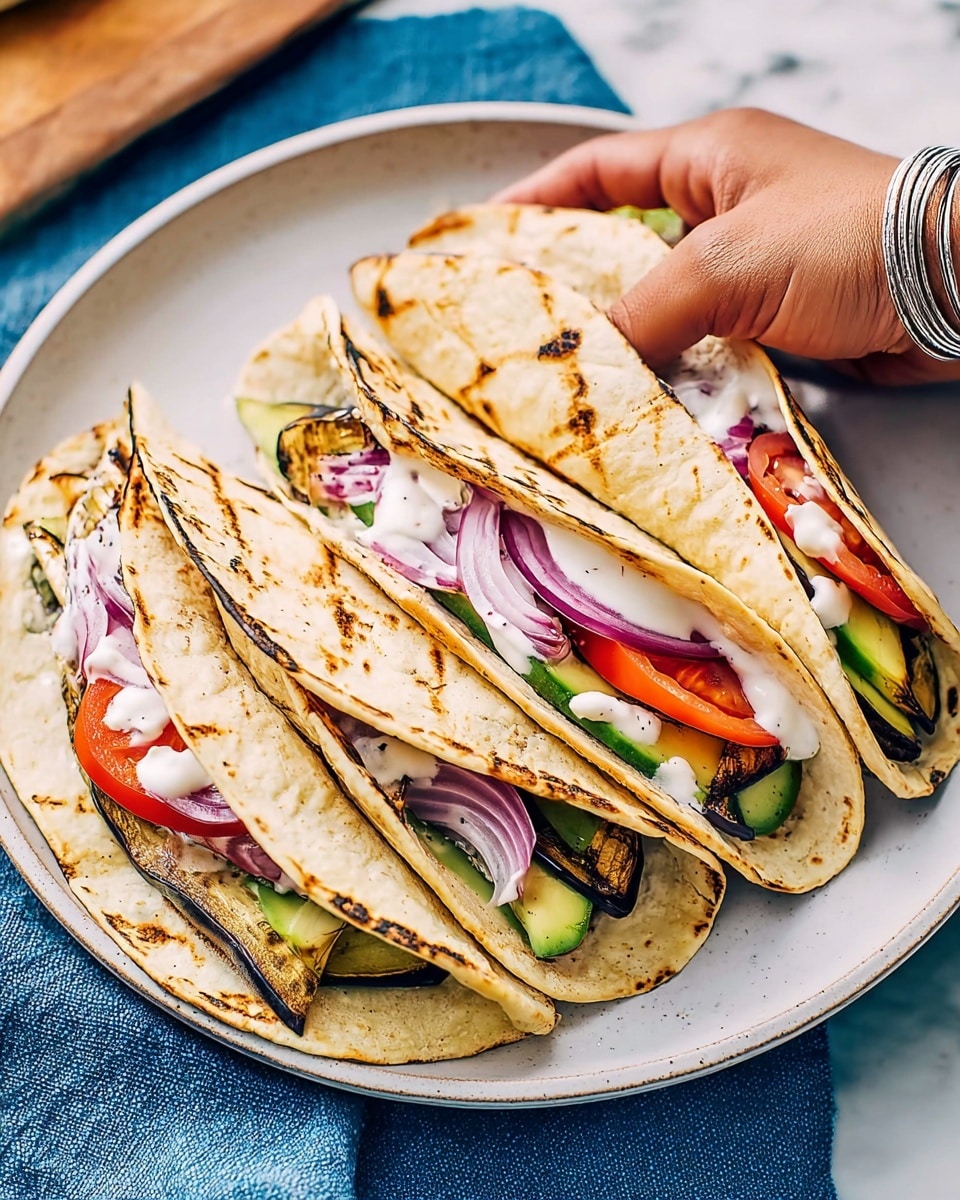 Three folded tortillas are placed closely on a white plate, each filled with layers of grilled brown slices with char marks, bright red tomato wedges, pink pickled onion strips, and slices of green avocado peeking out from the wraps. The tortillas have light brown spots from toasting. There is a small drizzle of white creamy sauce on top of the fillings. A woman's hand with a silver chain bracelet gently holds the rightmost tortilla. The plate is set on a white marbled surface with part of a blue cloth visible at the top edge. photo taken with an iphone --ar 4:5 --v 7