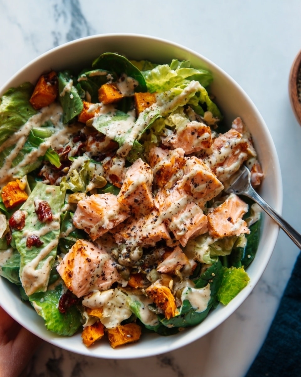A white bowl filled with a colorful salad layered from bottom to top: the base shows green leafy lettuce, followed by bright orange roasted sweet potato pieces, then a portion of grilled, slightly charred salmon with a pink center, topped with a generous drizzle of creamy dressing speckled with herbs; the woman's hand holds the bowl gently from the side, and the bowl sits on a white marbled surface with a dark cloth napkin beside it, warm natural light highlights the freshness and textures of the ingredients, photo taken with an iphone --ar 4:5 --v 7