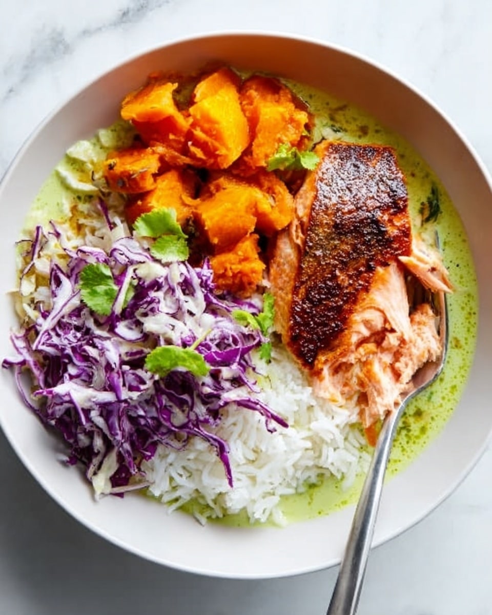 A white bowl filled with a layer of white rice on the right side, topped with grilled chicken pieces coated in a reddish-brown spice mix placed near the center. To the left of the chicken, there is a topping of shredded purple cabbage with a few small orange segments scattered on top. Underneath the bowl, the surface is a white marbled texture. A spoon with a silver handle rests on the right side, partially buried in the rice. photo taken with an iphone --ar 4:5 --v 7